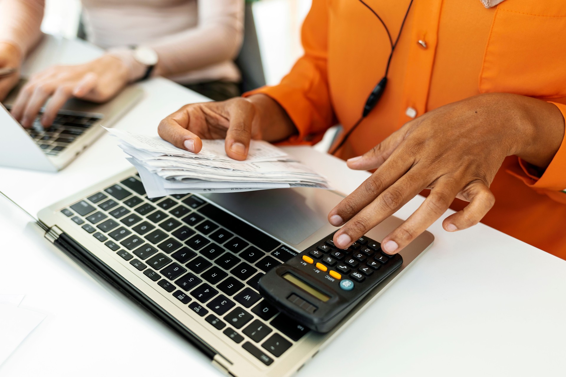 Person using calculator and counting bills